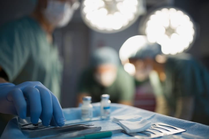 USMS | US Medical Systems | Surgeon reaching for instrument on tray operating room